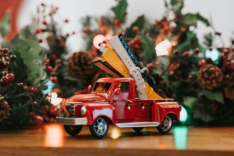 Christmas scene with toy truck hauling several watch bands