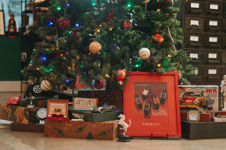 Christmas tree surrounded with presents and watch related decor