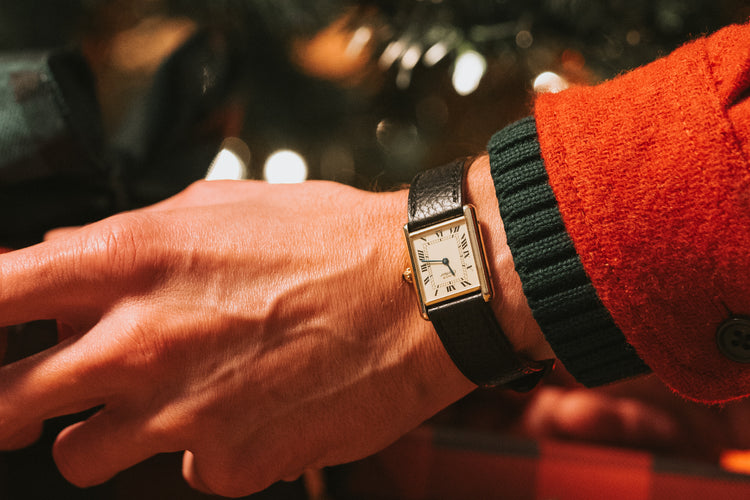 Vintage Cartier timepiece on a wrist in holiday setting